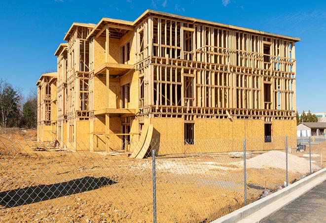 a temporary chain link fence locking away a building under renovation, serving as a security tool in Bethalto IL